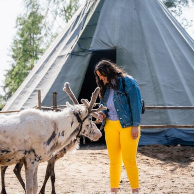 Solo traveler in Santa Claus Reindeer fence during summer