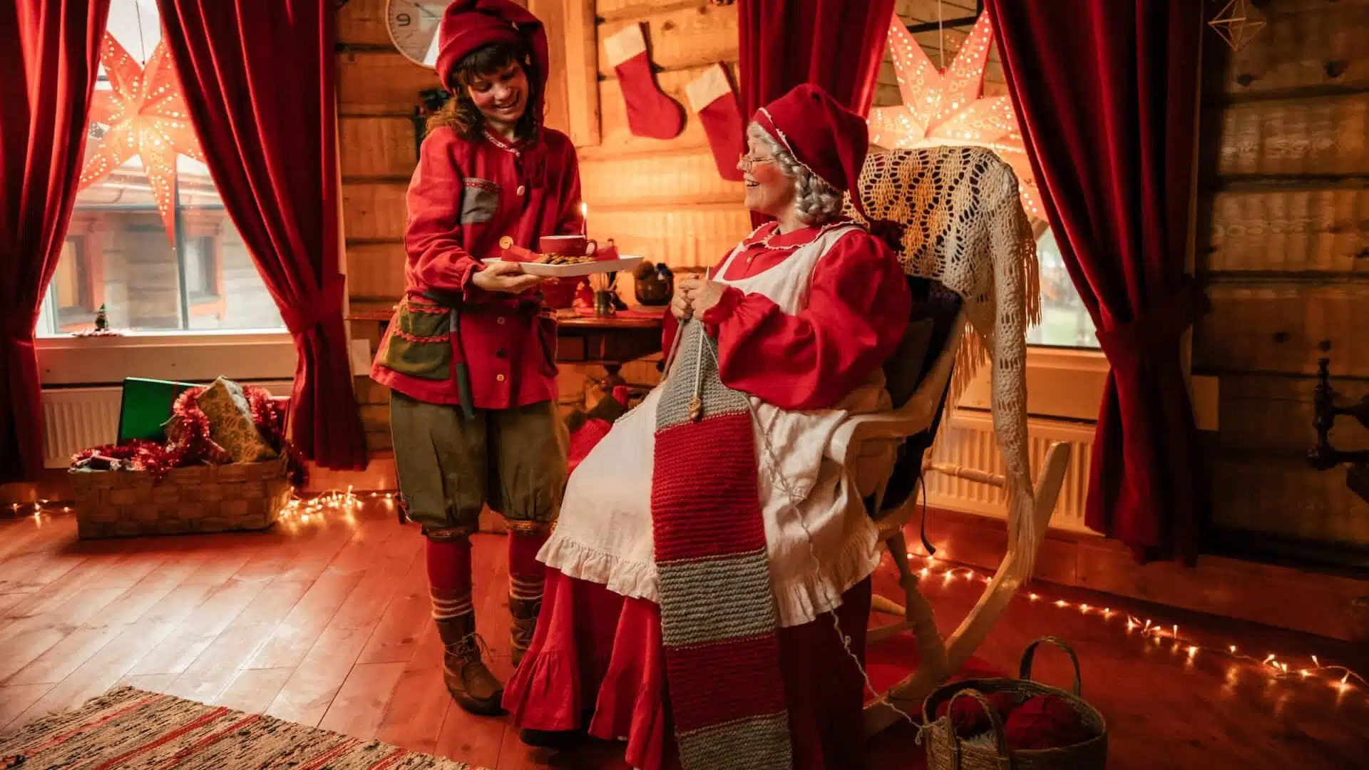 Mrs Santa Claus with a child in the Christmas Cottage