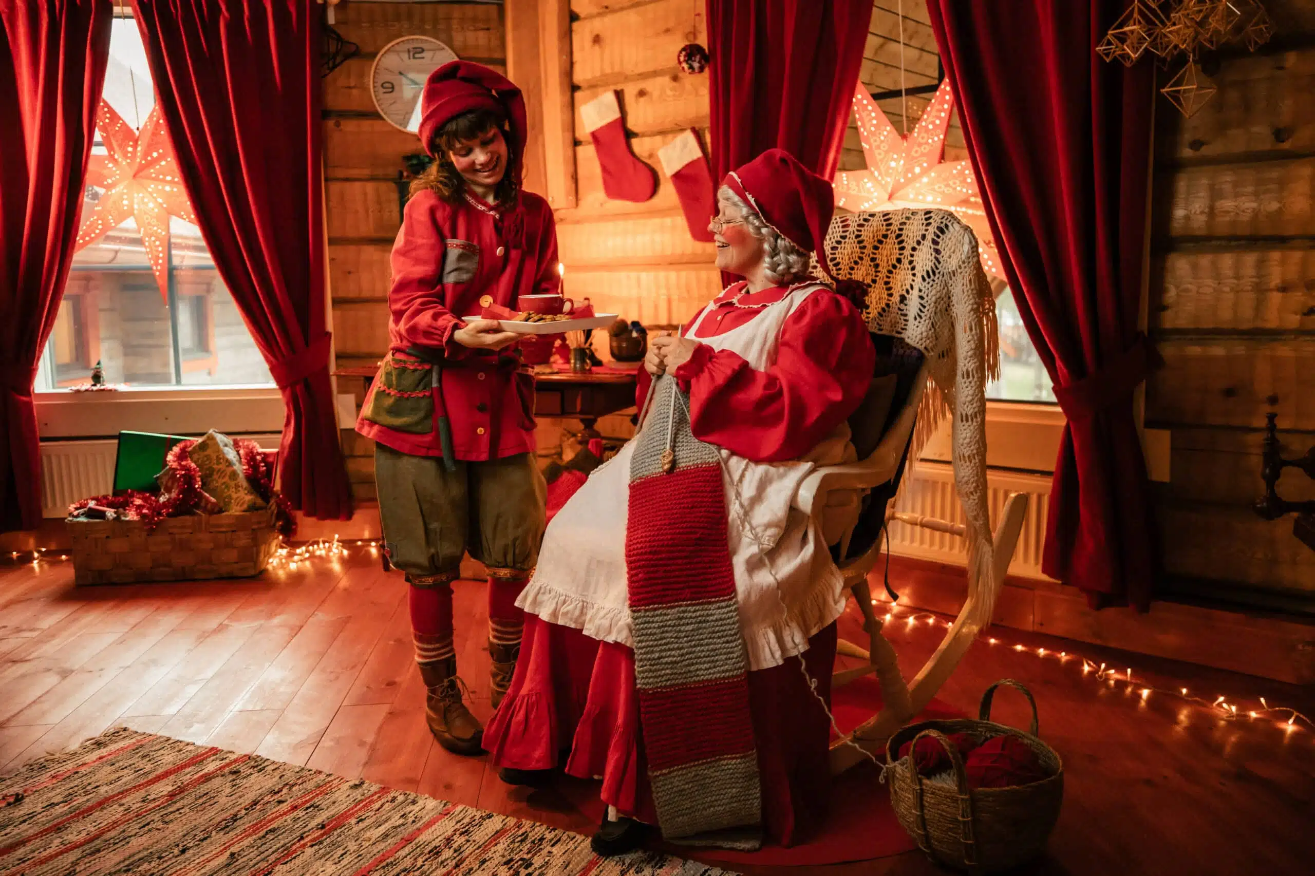 Elf offering treats to Mrs Santa Claus