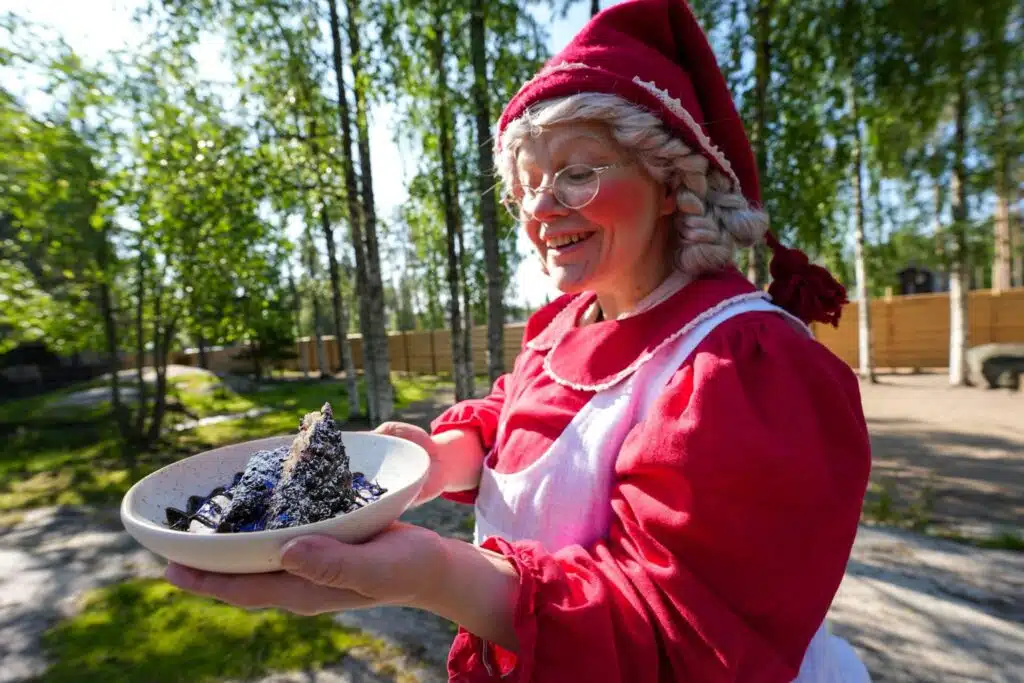 Mrs Santa Claus holding a dish at Santa Claus Village