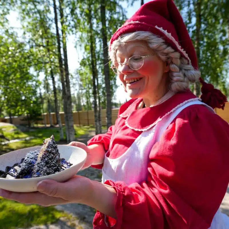 Mrs Santa Claus holding a dish at Santa Claus Village
